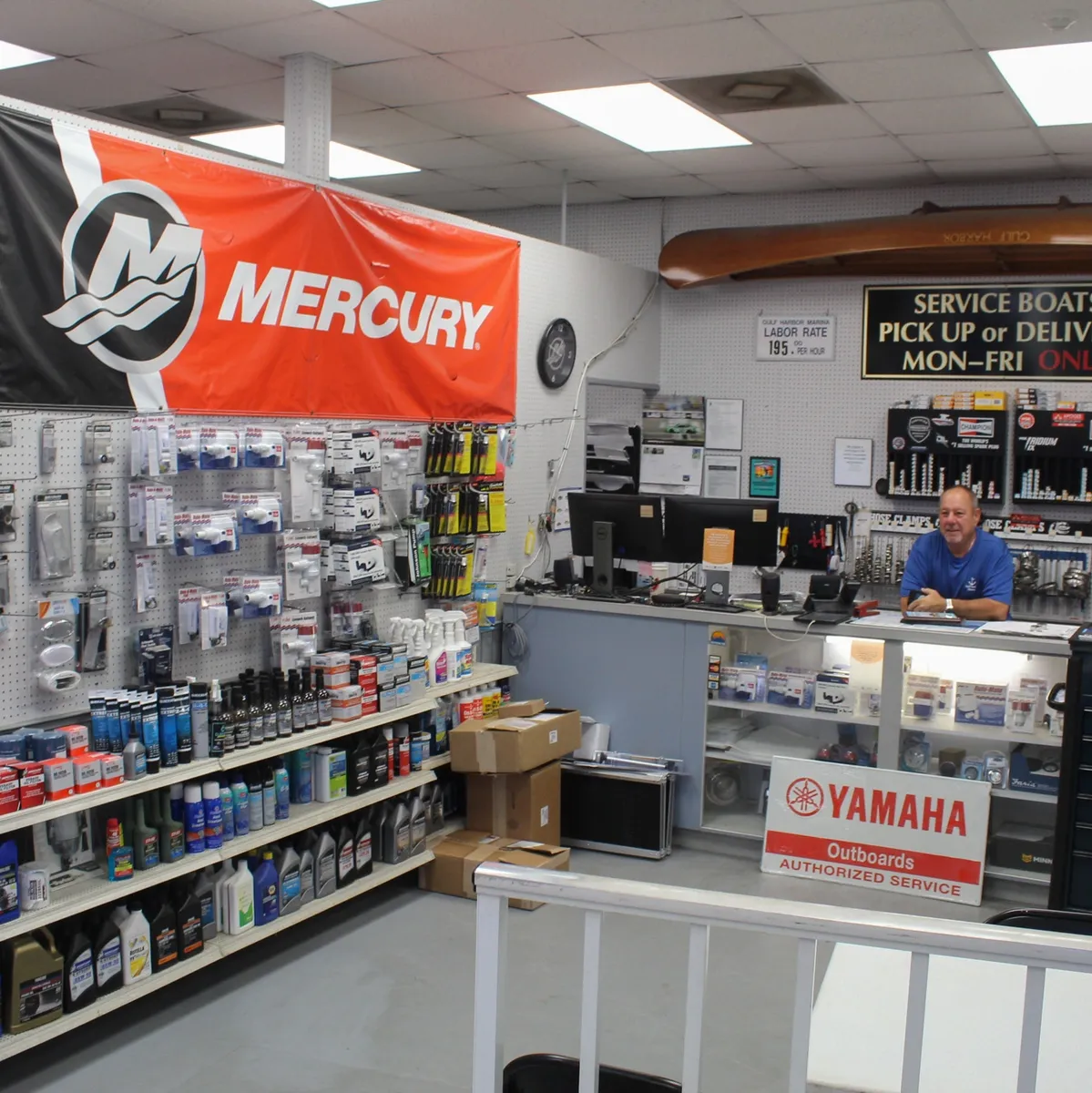 Inside the Gulf Harbor Marina Service parts counter, showing Mercury and Yamaha authorized service signage